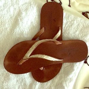 Brown and lace flip flops